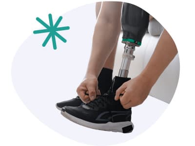 Person mit einer Beinprothese, die ihren Schuh bindet Person mit einer Beinprothese, die ihren Schuh bindet